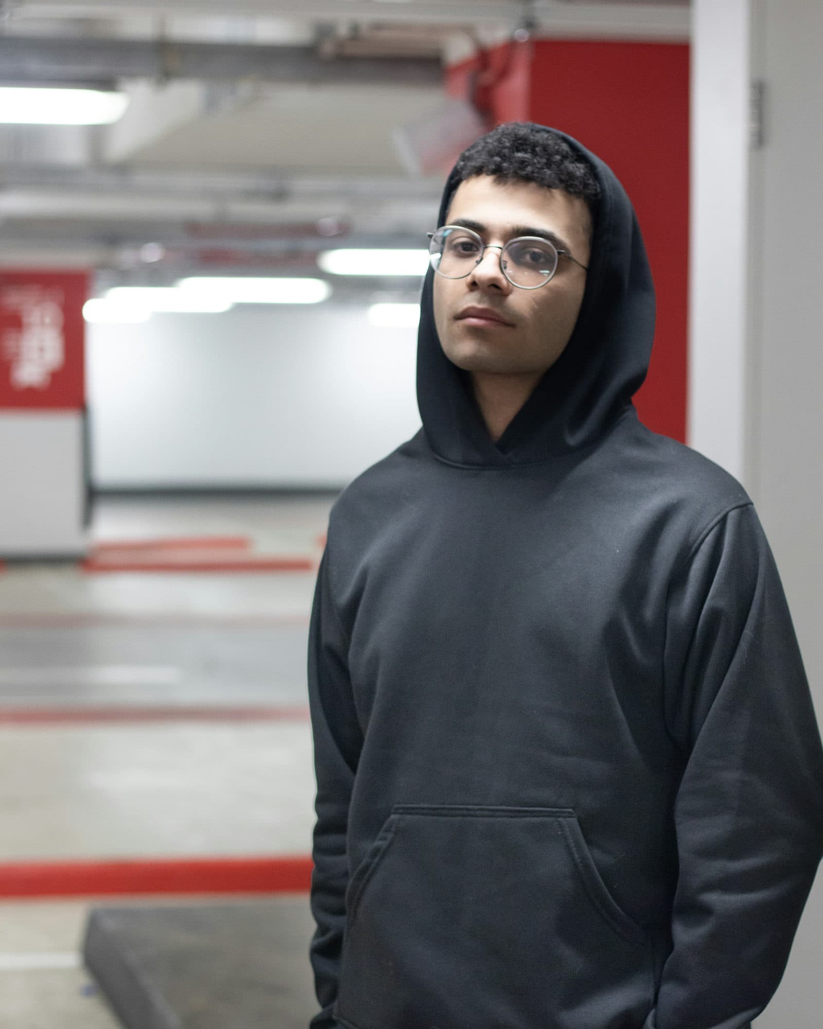 Model in an oversized streetwear hoodie, shot in low light